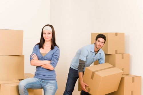 Removal workers loading boxes and furniture for a London home move