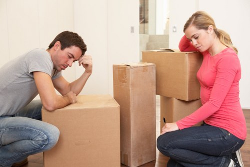 Professional removals team handling furniture in a modern Vauxhall apartment block